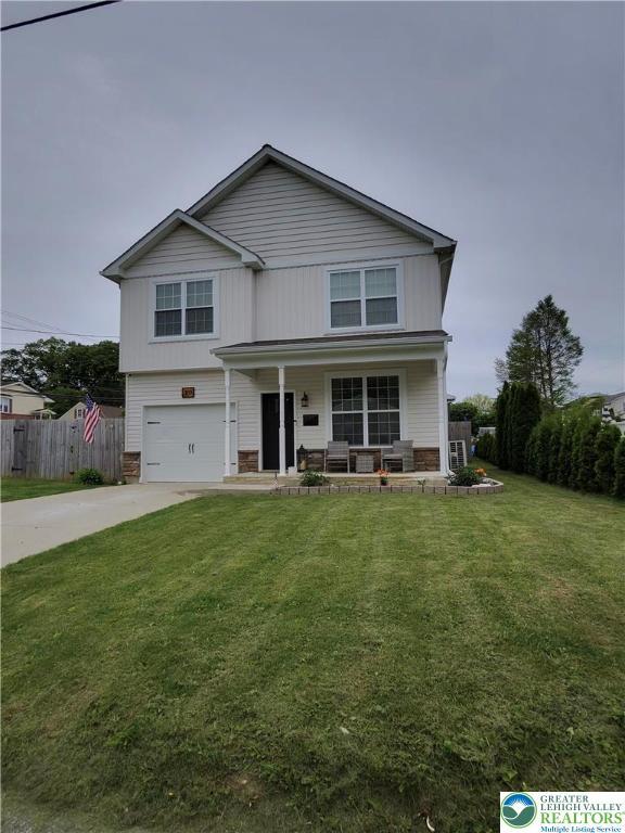 331 Minor St, Emmaus Borough, PA 18049 - view of front of property featuring an attached garage, concrete driveway, a porch, and stone siding