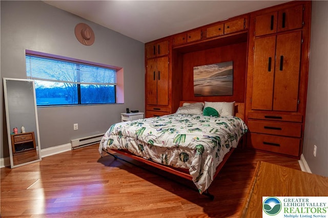 2107 3rd St, Bethlehem Twp, PA 18020 - bedroom featuring a baseboard radiator, light wood-type flooring, and baseboards