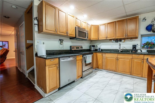 2107 3rd St, Bethlehem Twp, PA 18020 - kitchen with appliances with stainless steel finishes, a sink, brown cabinetry, a paneled ceiling, and recessed lighting