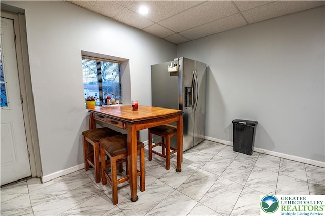 2107 3rd St, Bethlehem Twp, PA 18020 - dining space featuring light marble finish floors, baseboards, and a paneled ceiling