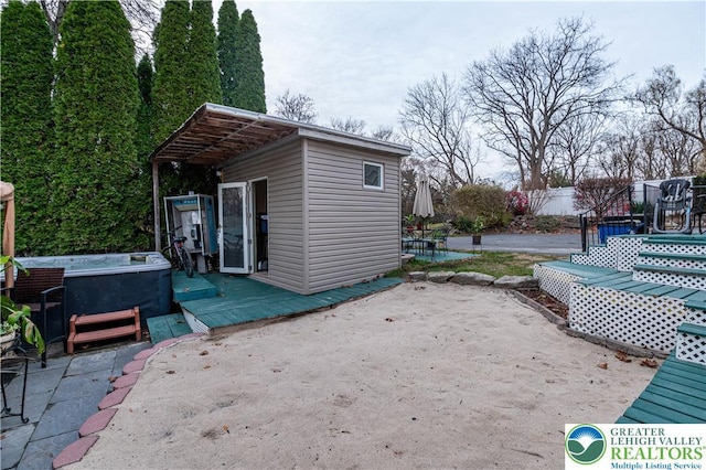 2107 3rd St, Bethlehem Twp, PA 18020 - view of patio featuring a hot tub, a wooden deck, and an outdoor structure