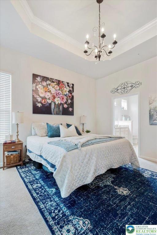 2585 Raya Way, Bethlehem Twp, PA 18045 - bedroom with a chandelier, ornamental molding, carpet, a raised ceiling, and connected bathroom