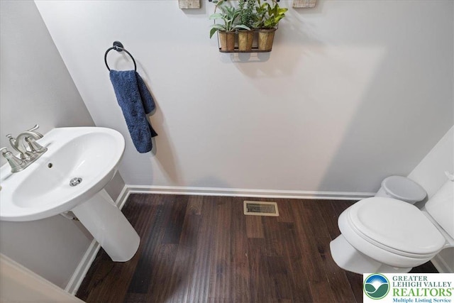 2585 Raya Way, Bethlehem Twp, PA 18045 - half bath featuring wood finished floors, baseboards, and toilet