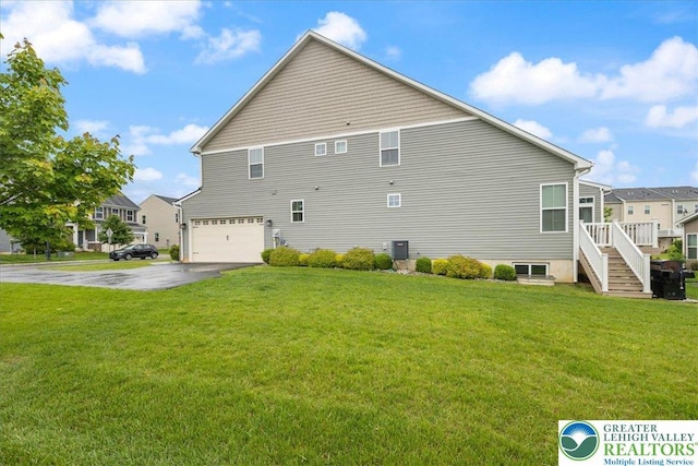 2585 Raya Way, Bethlehem Twp, PA 18045 - view of property exterior featuring driveway, a garage, cooling unit, and a lawn