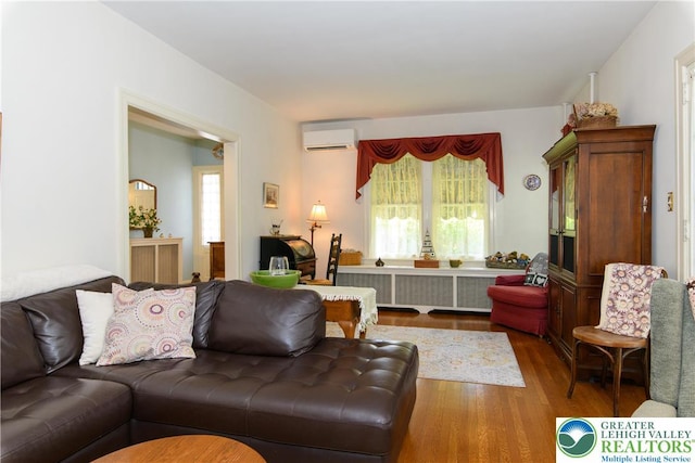 215 S 22nd St, Allentown City, PA 18104 - living room featuring radiator heating unit, wood finished floors, plenty of natural light, and an AC wall unit