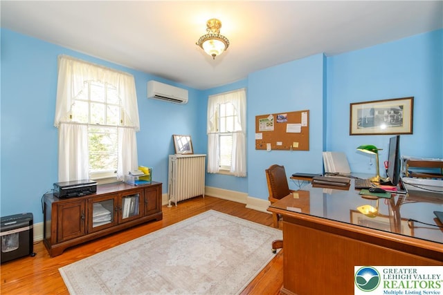 215 S 22nd St, Allentown City, PA 18104 - home office featuring a wall mounted air conditioner, radiator heating unit, wood finished floors, and baseboards