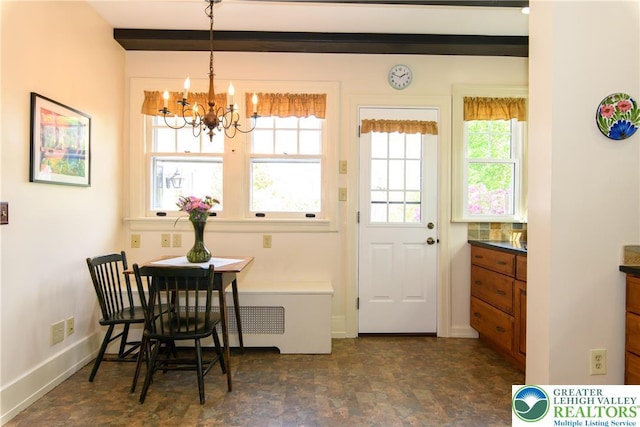 215 S 22nd St, Allentown City, PA 18104 - dining room featuring a chandelier, baseboards, and stone finish flooring