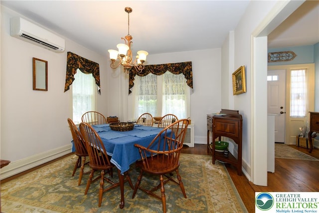 215 S 22nd St, Allentown City, PA 18104 - dining space featuring a chandelier, a wall unit AC, plenty of natural light, and wood finished floors