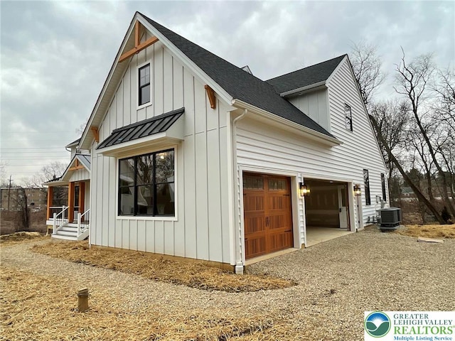 Blue Barn Rd Unit 1456, Upper Macungie Twp, PA 18104 - view of property exterior with board and batten siding, central AC, a shingled roof, driveway, and an attached garage