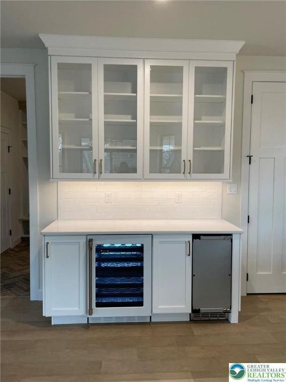 Blue Barn Rd Unit 1456, Upper Macungie Twp, PA 18104 - indoor dry bar featuring beverage cooler, backsplash, and light wood-style floors