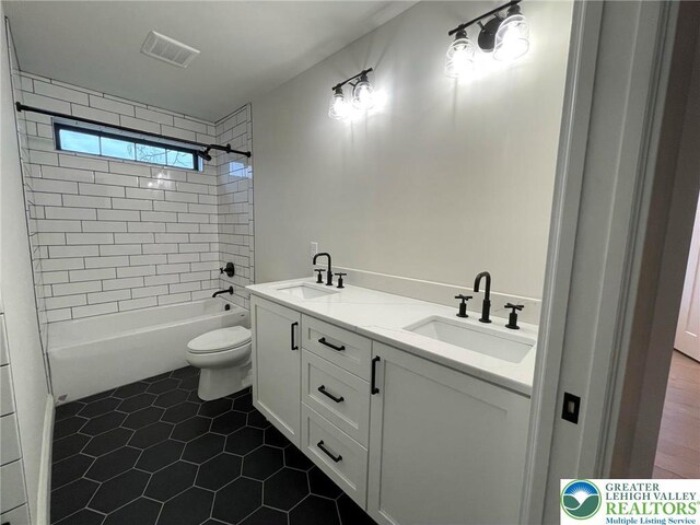 Blue Barn Rd Unit 1456, Upper Macungie Twp, PA 18104 - full bath with double vanity, toilet, washtub / shower combination, and tile patterned flooring