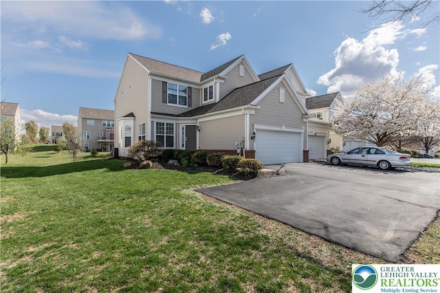 8604 Cascade Rd, Upper Macungie Twp, PA 18031 - view of property exterior featuring a yard, asphalt driveway, an attached garage, and brick siding