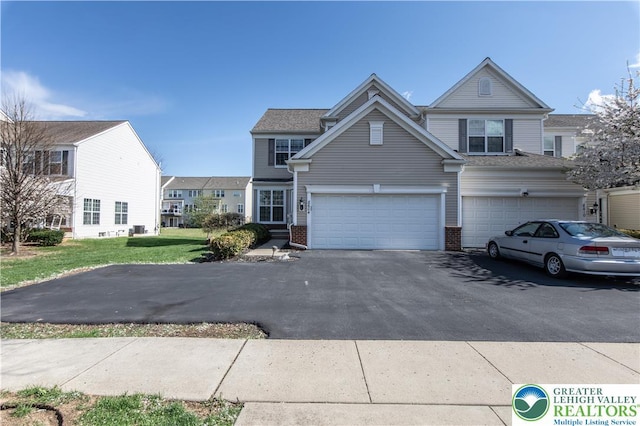 8604 Cascade Rd, Upper Macungie Twp, PA 18031 - view of front of property featuring driveway, brick siding, a garage, and a front yard