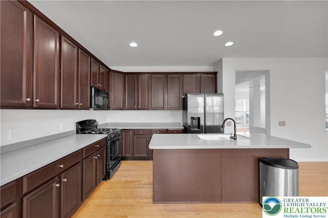 8604 Cascade Rd, Upper Macungie Twp, PA 18031 - kitchen with black appliances, a sink, light wood finished floors, light countertops, and recessed lighting