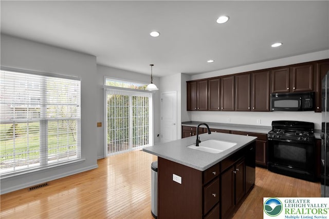 8604 Cascade Rd, Upper Macungie Twp, PA 18031 - kitchen featuring black appliances, a sink, light wood-style flooring, decorative light fixtures, and recessed lighting