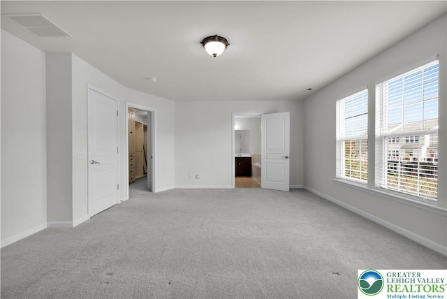 8604 Cascade Rd, Upper Macungie Twp, PA 18031 - unfurnished bedroom with light colored carpet, baseboards, and ensuite bathroom