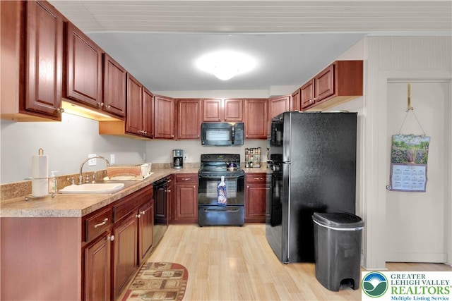 622 Scholl Ave, Salisbury Twp, PA 18015 - kitchen with black appliances, light countertops, light wood-style flooring, and a sink