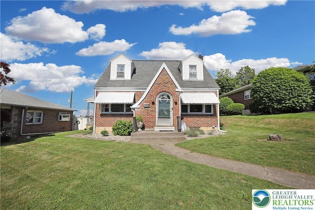 613 S Hoffert St, Fountain Hill Boro, PA 18015 - english style home with brick siding, a front yard, and a chimney