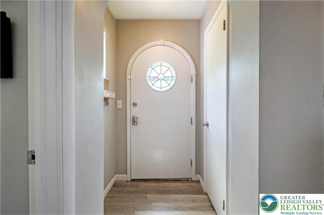 613 S Hoffert St, Fountain Hill Boro, PA 18015 - doorway with light wood finished floors, baseboards, and arched walkways