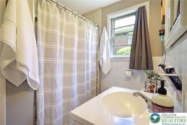 613 S Hoffert St, Fountain Hill Boro, PA 18015 - bathroom with tile walls, vanity, and a shower with shower curtain