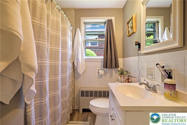 613 S Hoffert St, Fountain Hill Boro, PA 18015 - bathroom with radiator heating unit, toilet, vanity, and tile walls