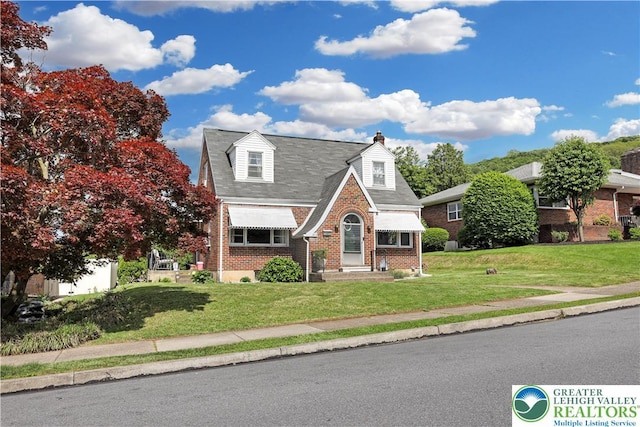 613 S Hoffert St, Fountain Hill Boro, PA 18015 - view of front of property featuring brick siding, a front lawn, and a chimney