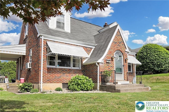 613 S Hoffert St, Fountain Hill Boro, PA 18015 - view of front of home with brick siding, a front yard, and a shingled roof