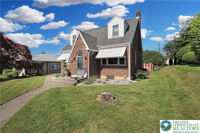 613 S Hoffert St, Fountain Hill Boro, PA 18015 - view of front facade featuring brick siding, a chimney, a front yard, and roof with shingles