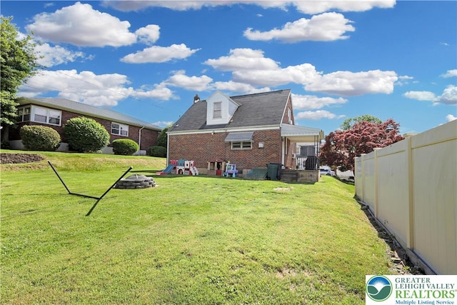 613 S Hoffert St, Fountain Hill Boro, PA 18015 - rear view of house featuring brick siding, a fire pit, and a chimney