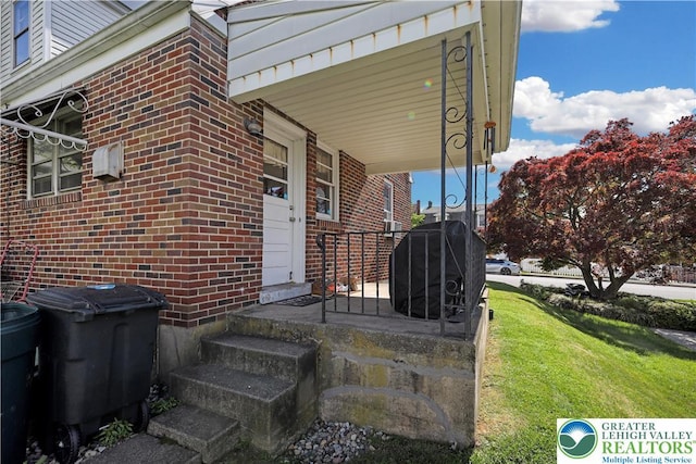 613 S Hoffert St, Fountain Hill Boro, PA 18015 - entrance to property featuring brick siding and a lawn