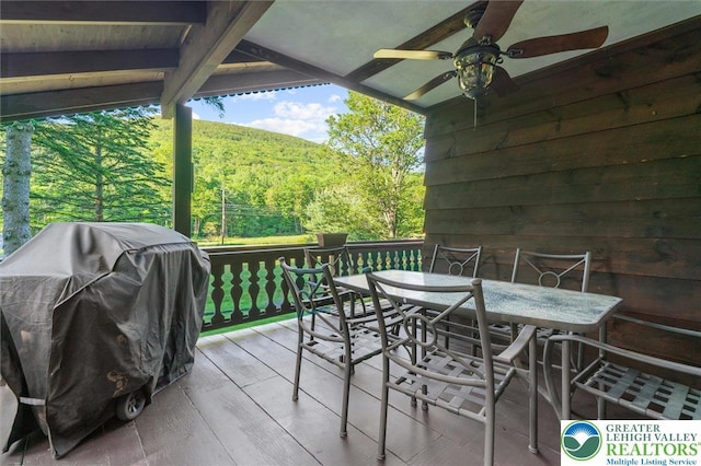 160 Camelback Rd, Pocono Twp, PA 18372 - wooden terrace with outdoor dining space, a grill, a forest view, and a ceiling fan