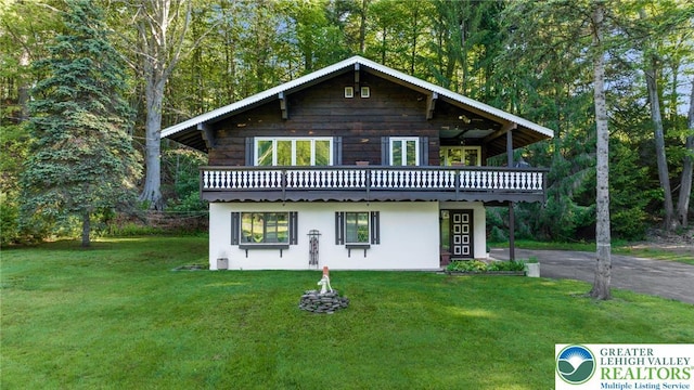 160 Camelback Rd, Pocono Twp, PA 18372 - view of front of property featuring a front lawn, a deck, stucco siding, and asphalt driveway
