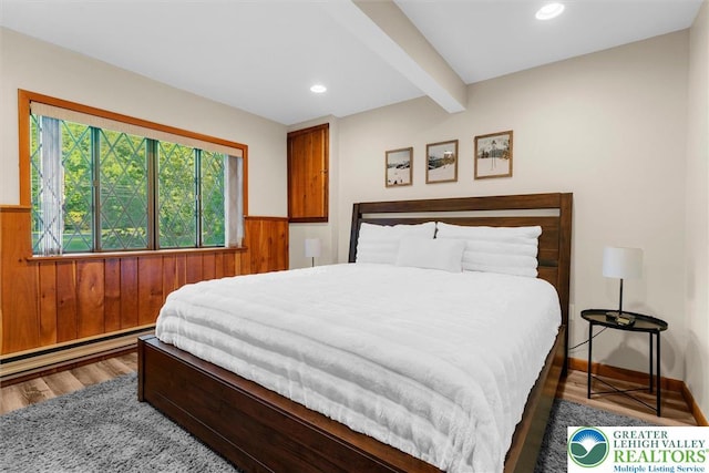 160 Camelback Rd, Pocono Twp, PA 18372 - bedroom with wood finished floors, beam ceiling, wood walls, wainscoting, and baseboard heating