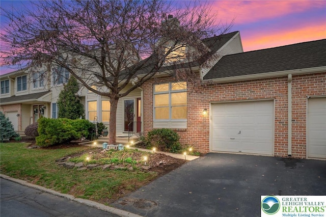 275 Ridings Cir, Macungie Borough, PA 18062 - view of front facade with brick siding, roof with shingles, asphalt driveway, and a garage