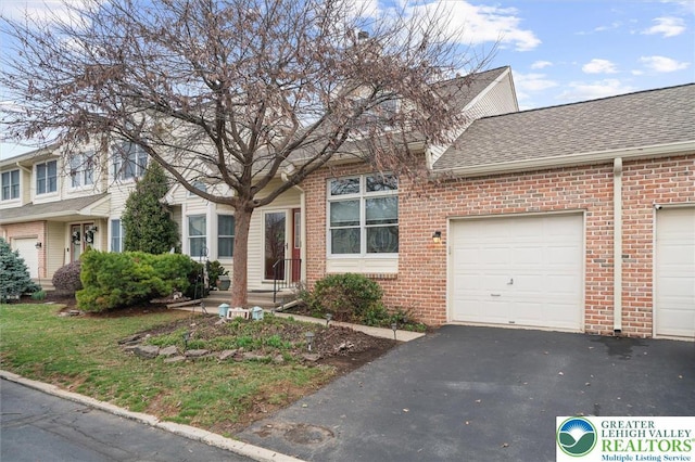 275 Ridings Cir, Macungie Borough, PA 18062 - view of front of property with a shingled roof, brick siding, asphalt driveway, and a garage