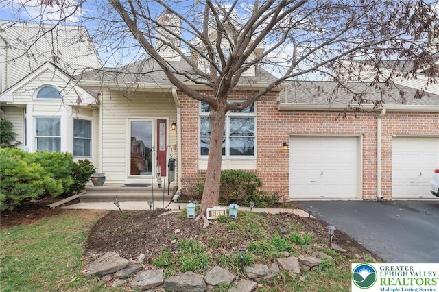 275 Ridings Cir, Macungie Borough, PA 18062 - view of front of property featuring brick siding, driveway, and roof with shingles