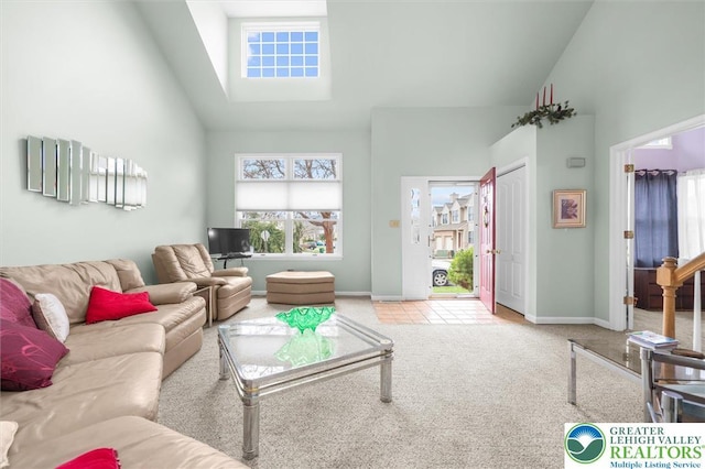 275 Ridings Cir, Macungie Borough, PA 18062 - living area with high vaulted ceiling, carpet floors, baseboards, and a skylight
