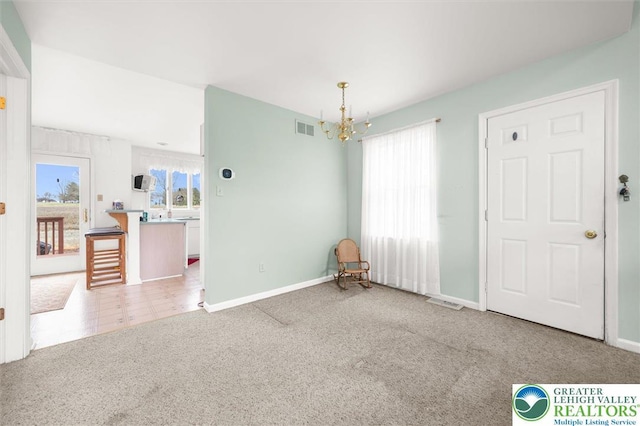 275 Ridings Cir, Macungie Borough, PA 18062 - unfurnished dining area featuring a chandelier, healthy amount of natural light, carpet flooring, and baseboards