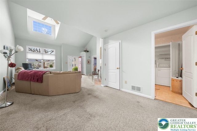 275 Ridings Cir, Macungie Borough, PA 18062 - carpeted living area with washer / dryer, ceiling fan, baseboards, and vaulted ceiling