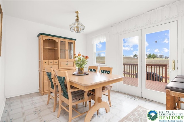 275 Ridings Cir, Macungie Borough, PA 18062 - dining room with light floors, a chandelier, and baseboards
