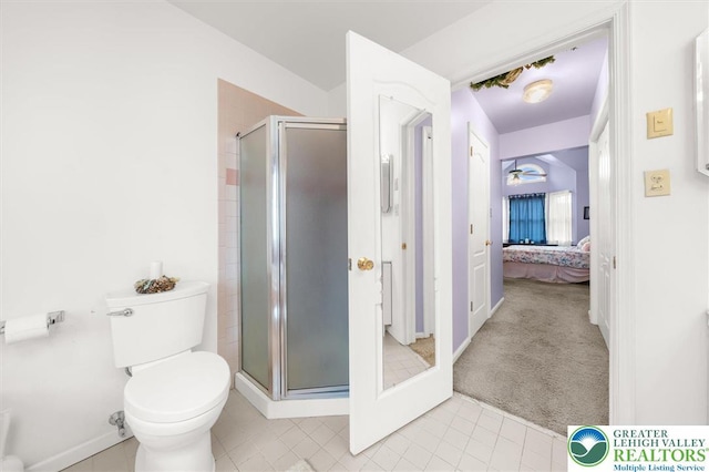 275 Ridings Cir, Macungie Borough, PA 18062 - ensuite bathroom featuring a stall shower, toilet, tile patterned flooring, and baseboards