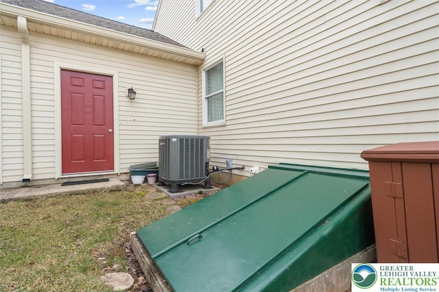 275 Ridings Cir, Macungie Borough, PA 18062 - exterior view of central AC, a bulkhead entry, and a shingled roof