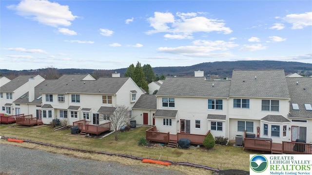 275 Ridings Cir, Macungie Borough, PA 18062 - rear view of house with a residential view, a wooden deck, central AC, and a lawn