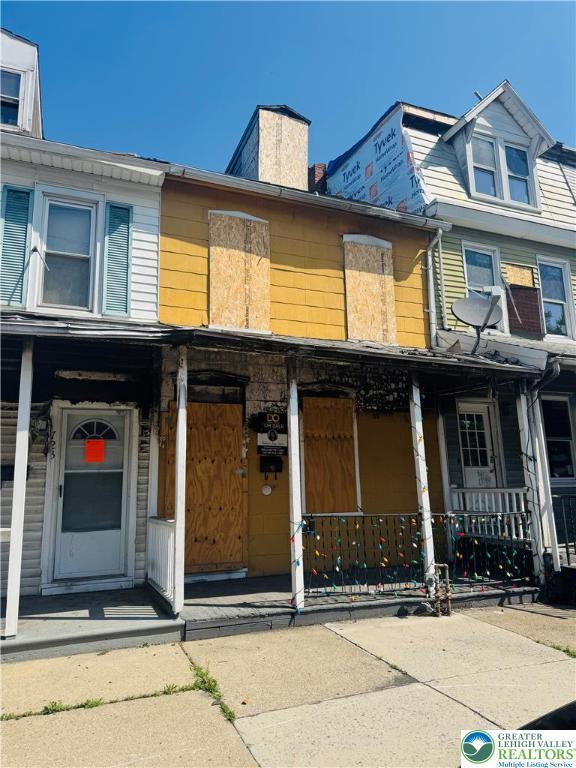 721 W Cedar St, Allentown City, PA 18102 - townhome / multi-family property featuring covered porch and a chimney