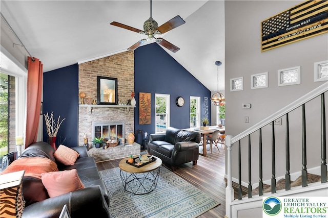5401 Hale Ave, Hanover Twp, PA 18017 - living area with wood finished floors, a ceiling fan, stairway, a brick fireplace, and high vaulted ceiling