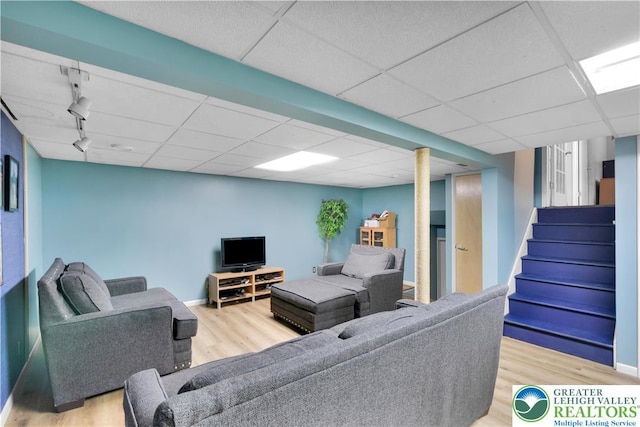 5401 Hale Ave, Hanover Twp, PA 18017 - living room featuring wood finished floors, rail lighting, a drop ceiling, and stairway