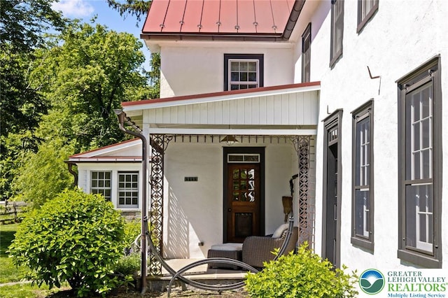 408 Kintner Hill Rd, Nockamixon Twp, PA 18972 - view of exterior entry featuring a standing seam roof, stucco siding, and metal roof