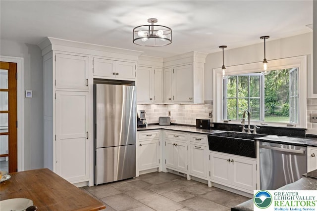 408 Kintner Hill Rd, Nockamixon Twp, PA 18972 - kitchen with stainless steel appliances, dark countertops, a sink, tasteful backsplash, and white cabinetry