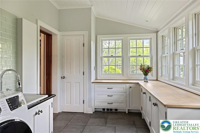 408 Kintner Hill Rd, Nockamixon Twp, PA 18972 - washroom with cabinet space, washer / clothes dryer, dark tile patterned floors, and crown molding