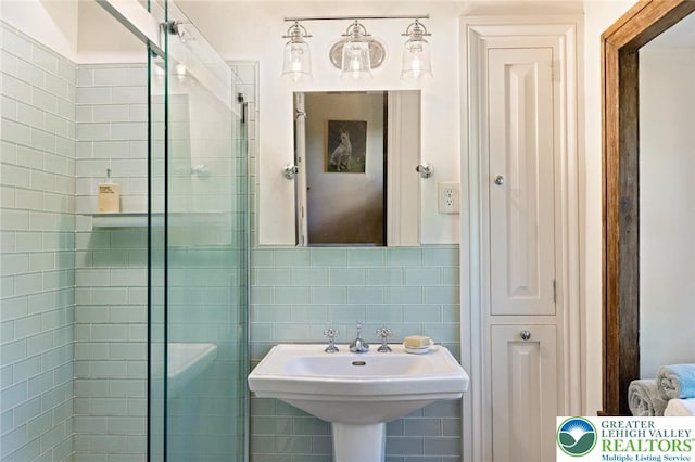 408 Kintner Hill Rd, Nockamixon Twp, PA 18972 - bathroom featuring a stall shower, tile walls, and a sink